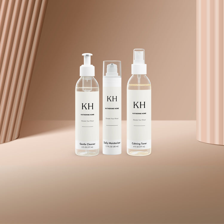 Katherine Home luxury skincare bottles and jars arranged on a clean white background with a soft, elegant glow.