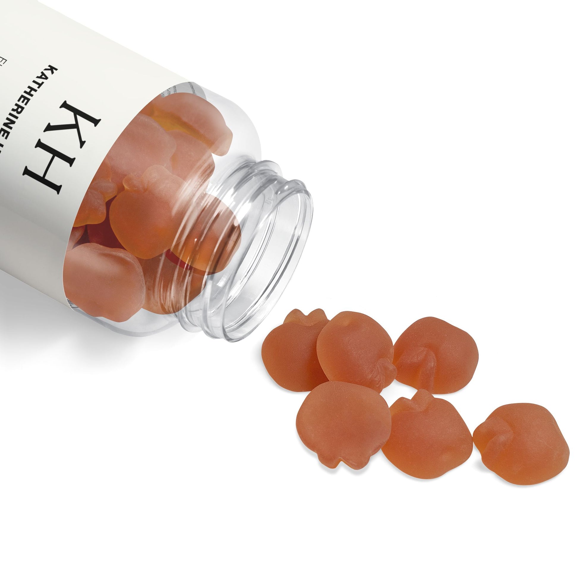 KH bottle tipped on its side with gummies spilling onto a clean white surface.