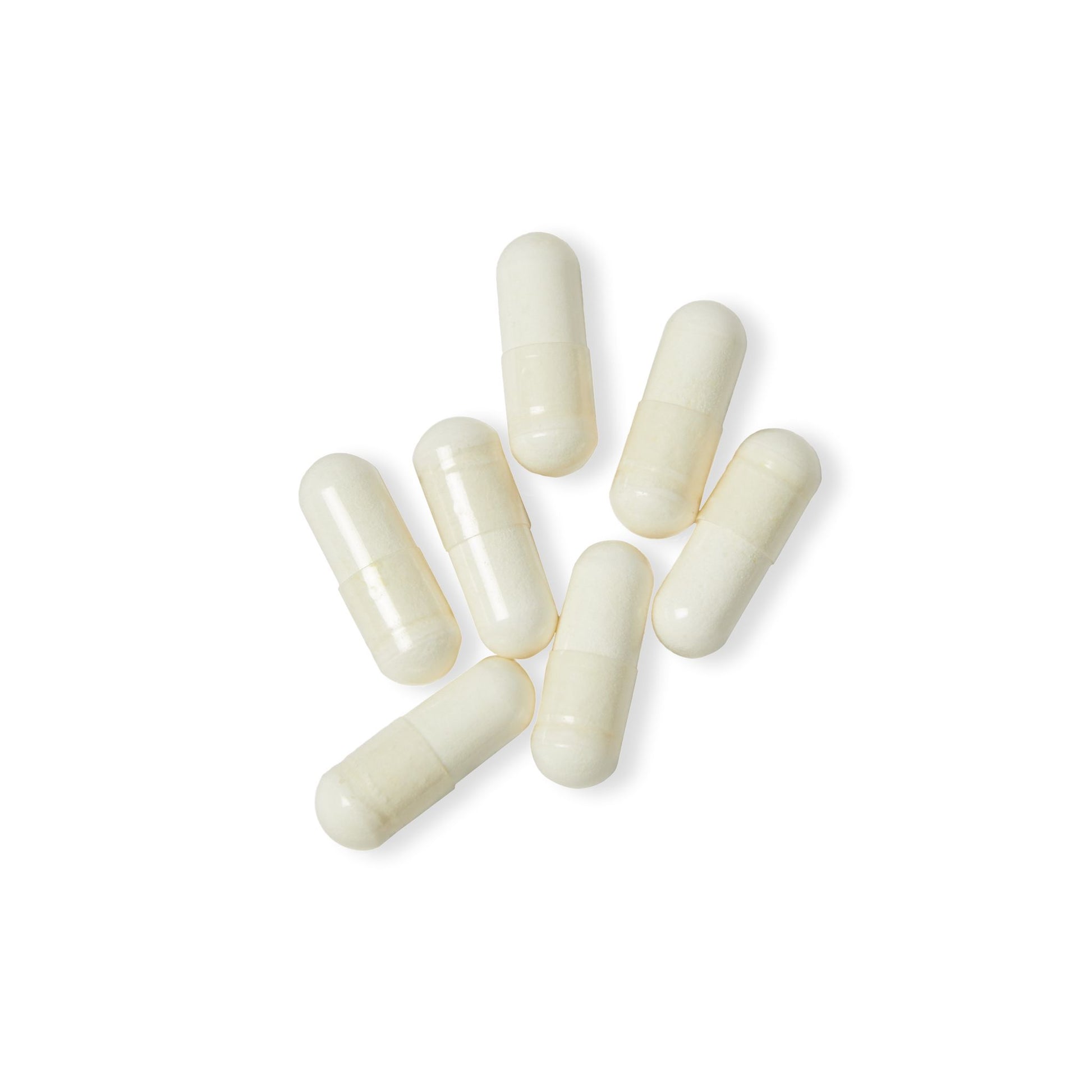 Macro shot of clean, clear vegetable capsules on a white background.