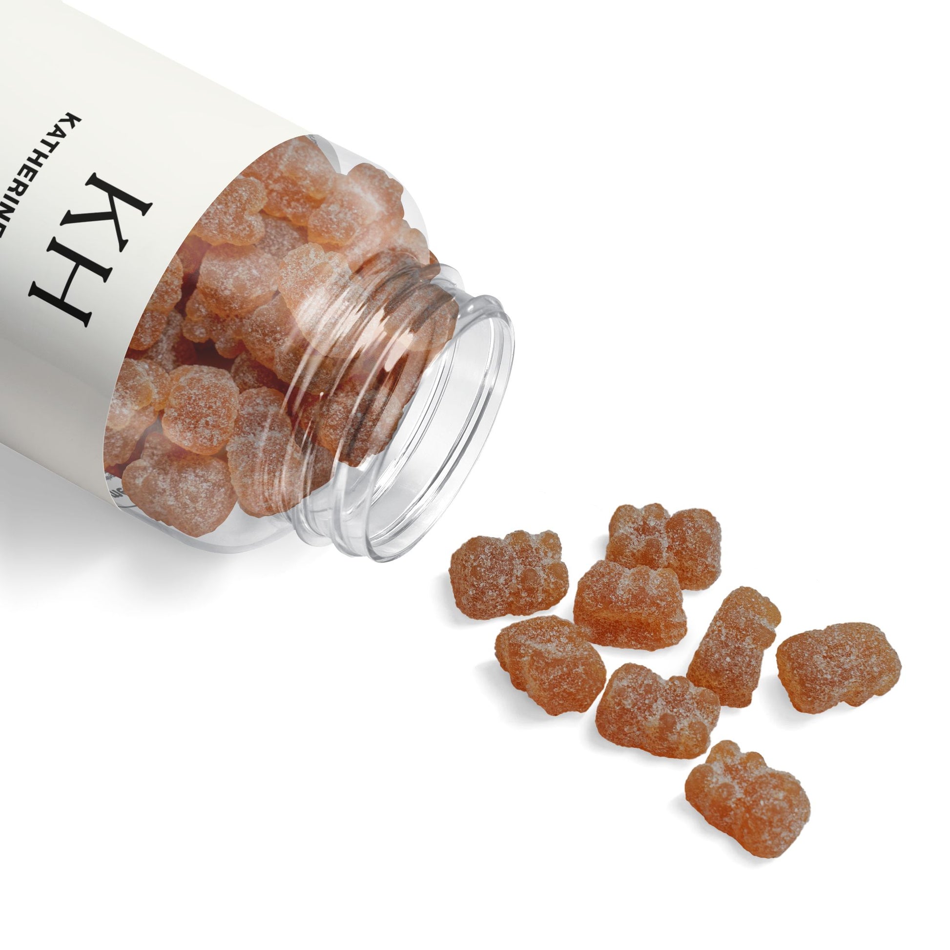  Open bottle tipped on its side with gummies spilled on a clean white surface to showcase texture and form.