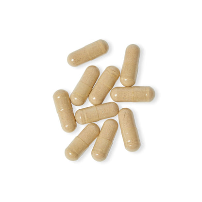 Loose vegetable capsules displayed on a white background to show shape and size.