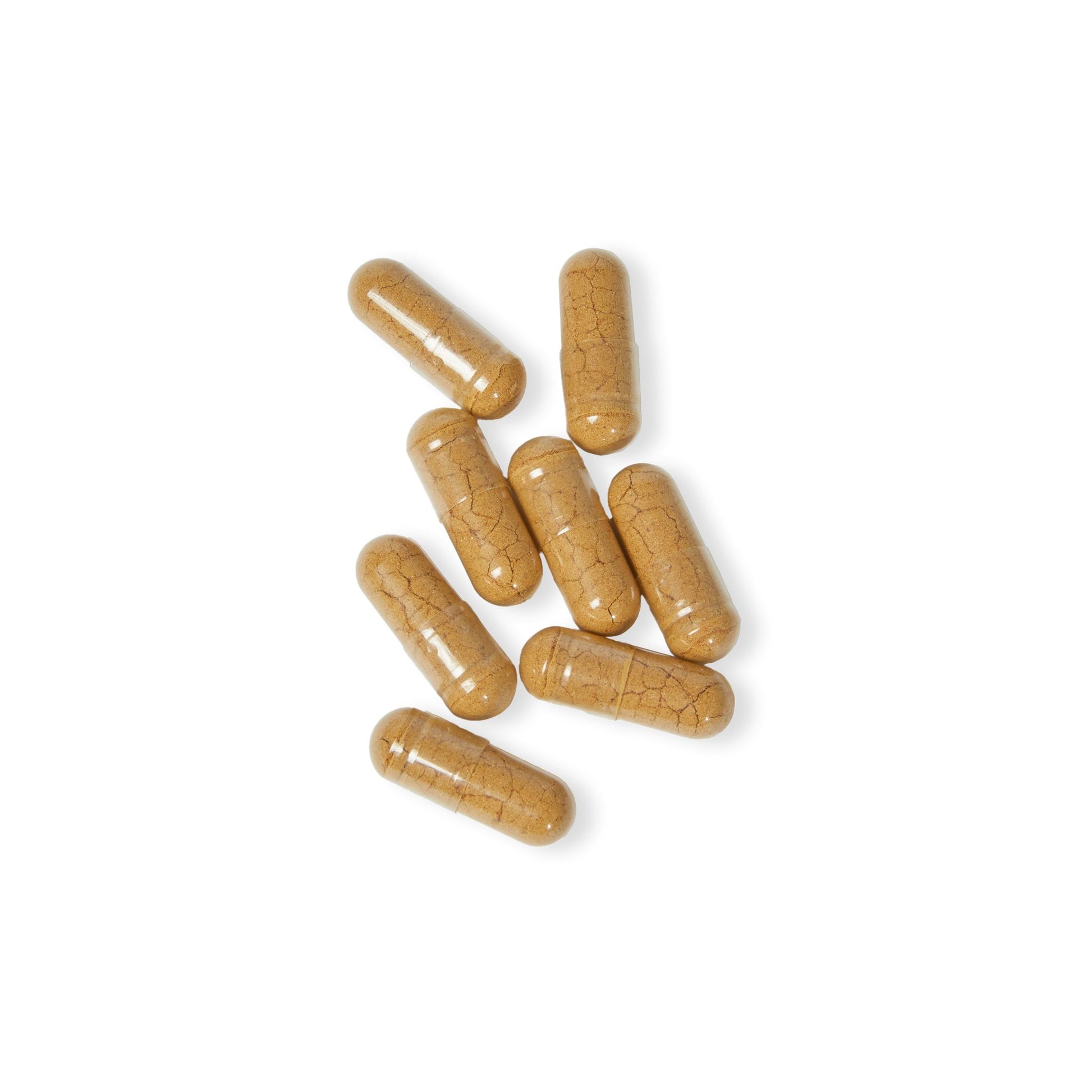 Loose vegetable capsules displayed on a white background to show size and texture.