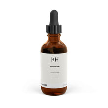 Amber glass bottle of Katherine Home Hair Oil with black dropper, front view, 2 fl oz